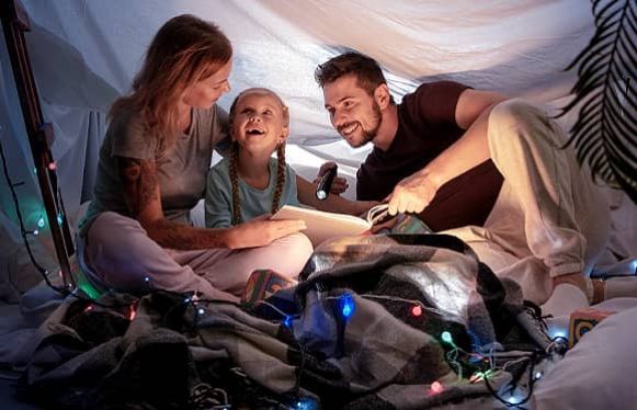 family keeping warm under blankets