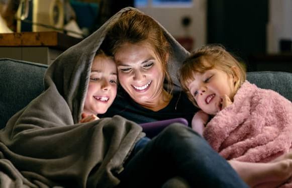 family keeping warm under blankets